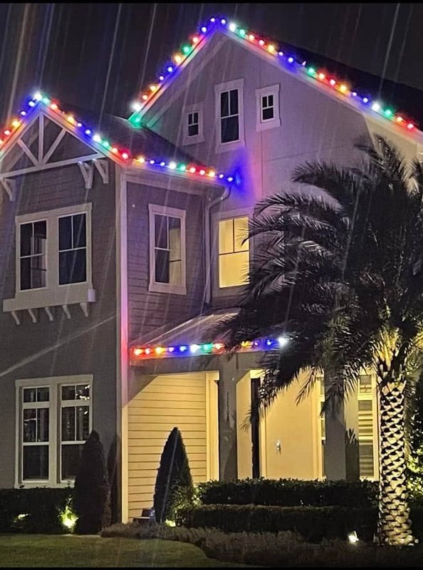 Multi-color holiday lighting on two-story home
