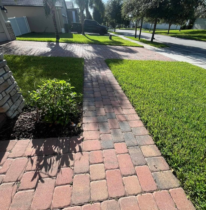 Brick walkway with landscape lighting